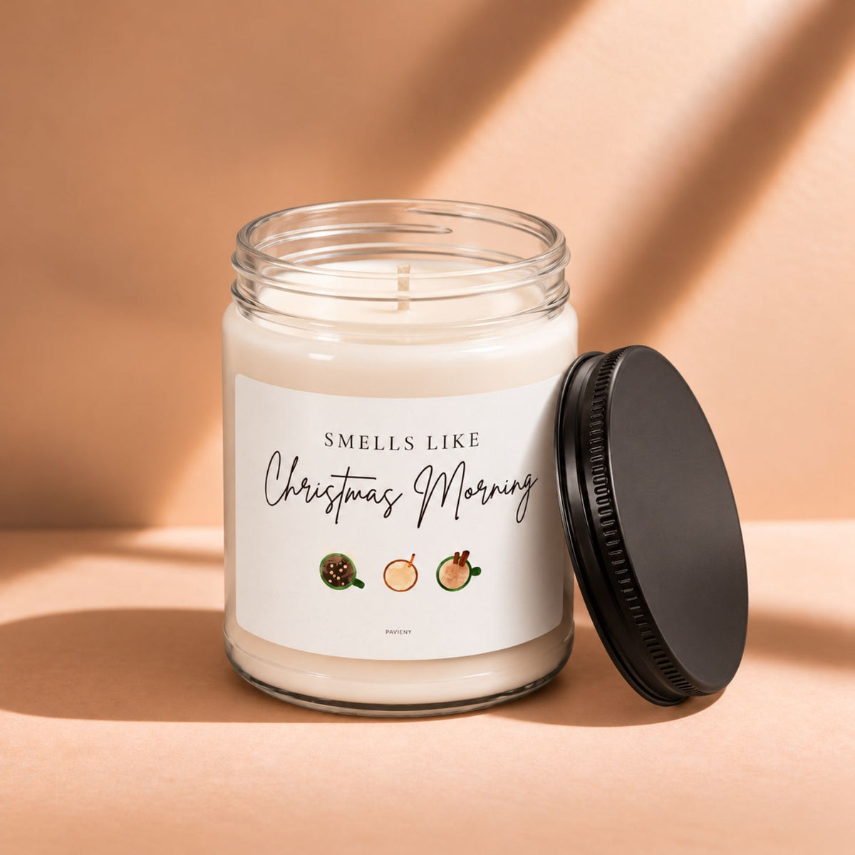 Open 9oz Christmas Morning scented soy candle with the black lid beside the clear glass jar.