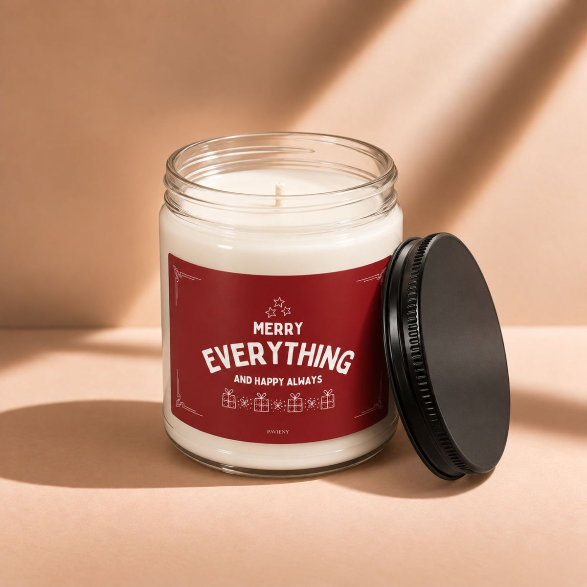Open 9oz Merry Everything candle with the black lid beside the glass jar.