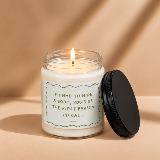Lit Hide a Body funny candle by Pavieny in a glass jar, a dark humor novelty gift for friends with a sarcastic sense of humor.