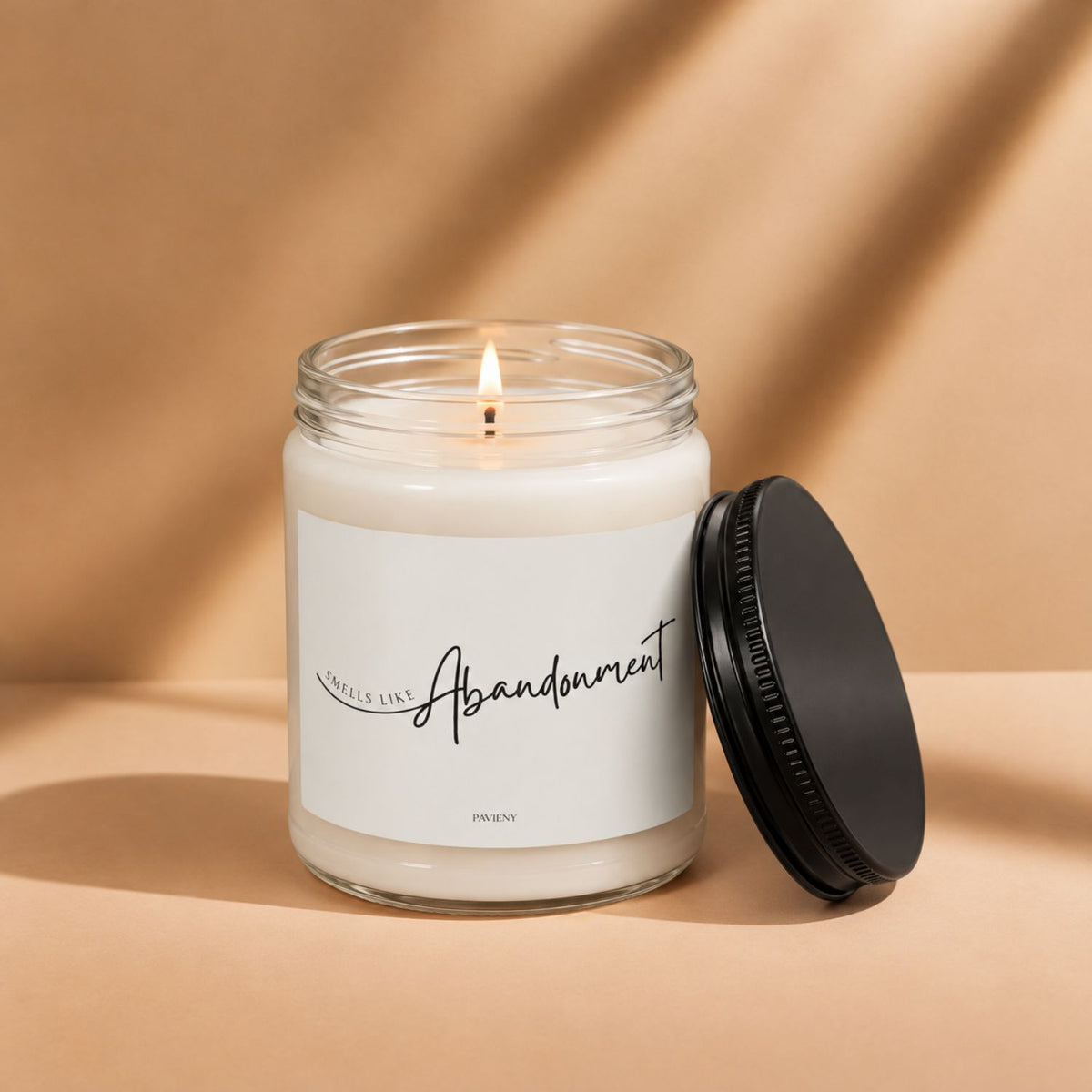 Lit Smells Like Abandonment candle by Pavieny in a glass jar, a sarcastic novelty gift for friends who appreciate dark humor.