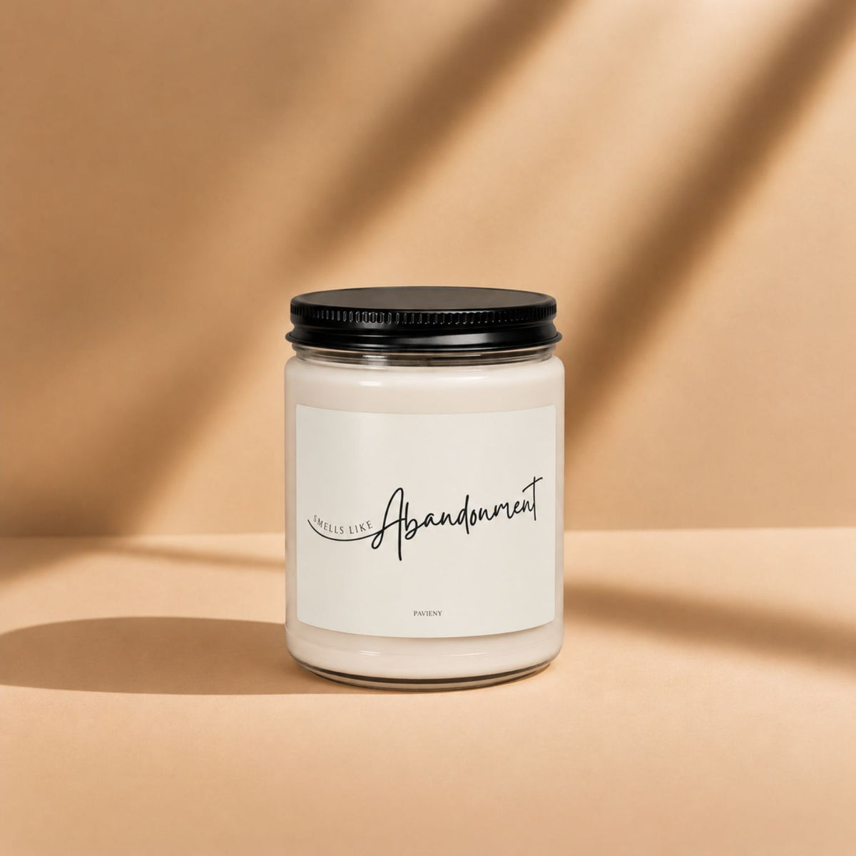 Smells Like Abandonment novelty candle by Pavieny with its sarcastic label displayed on the closed glass jar.