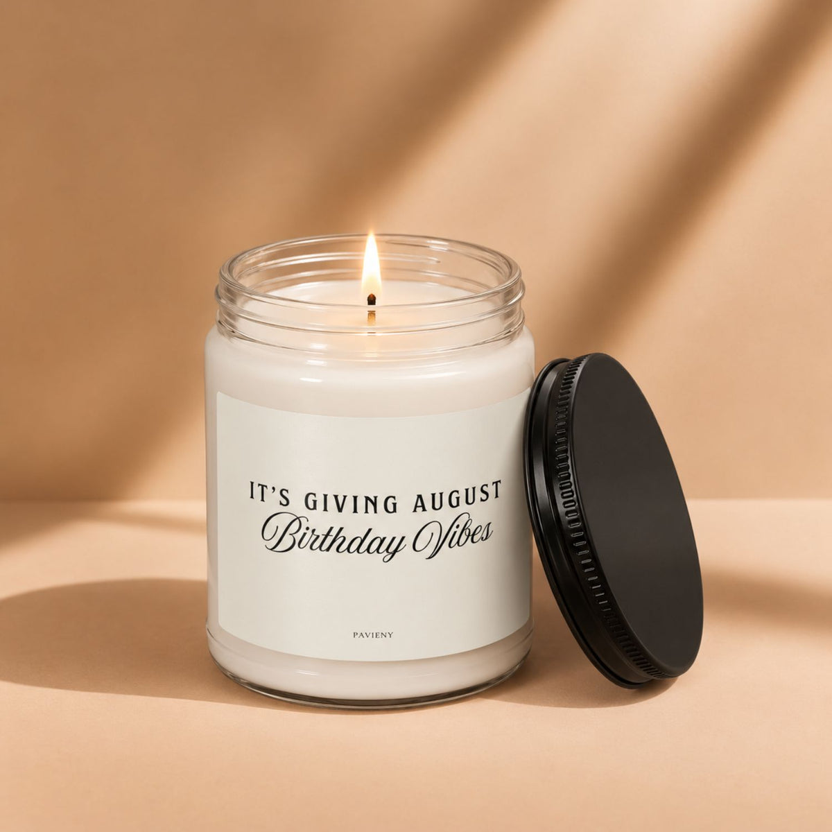 Lit August birthday scented candle in a glass jar, a thoughtful birthday gift for someone born in August.