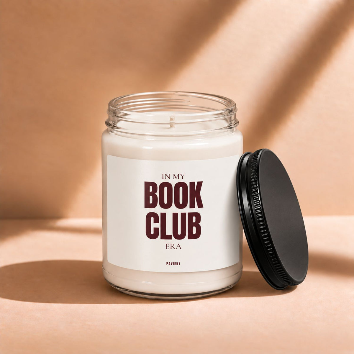 Open 9oz Book Club scented candle with the black lid beside the glass jar.