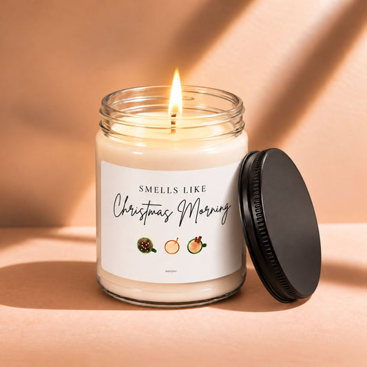 Lit 9oz Christmas Morning scented soy candle with a warm flame, a cozy Christmas gift.