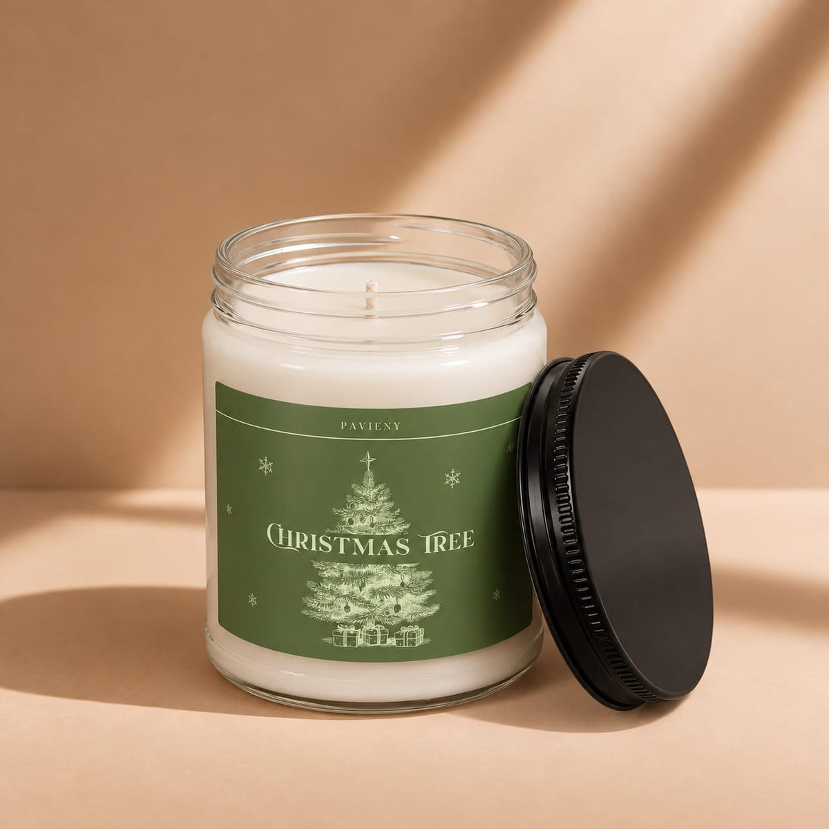 Open 9oz Christmas Tree scented soy candle with the black lid beside the clear glass jar.