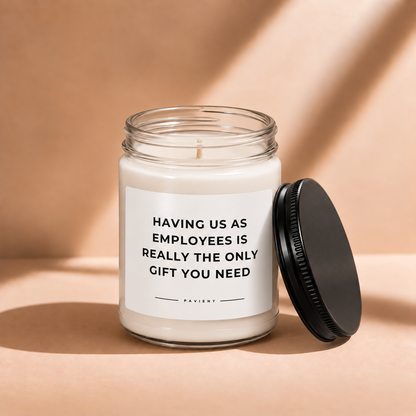 Open 9oz Employees Are Gifts scented soy candle with the black lid beside the clear glass jar.