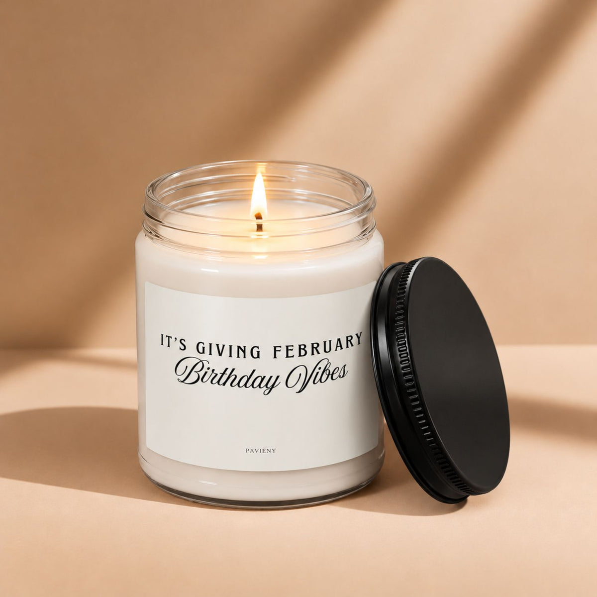 Lit February birthday scented candle in a glass jar, a thoughtful birthday gift for February birthdays.