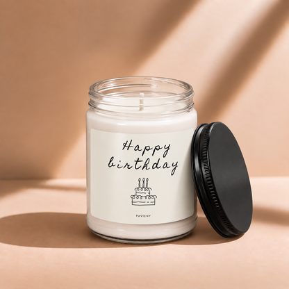Open 9oz Happy Birthday scented soy candle with the black lid beside the clear glass jar.