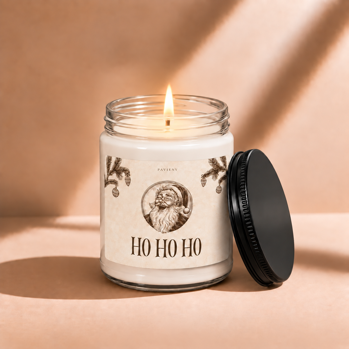Lit 9oz Ho Ho Ho scented soy candle with a warm flame, a festive Christmas gift for the holiday season.
