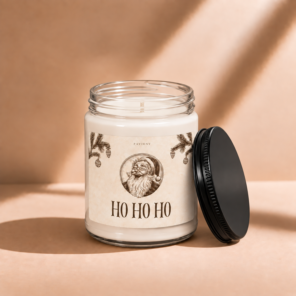 Open 9oz Ho Ho Ho scented soy candle with the black lid beside the clear glass jar.