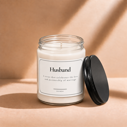 Open 9oz Husband scented soy candle with the black lid beside the clear glass jar.
