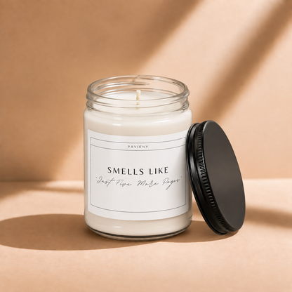 Open 9oz Just Five More Pages scented soy candle with the black lid beside the clear glass jar.