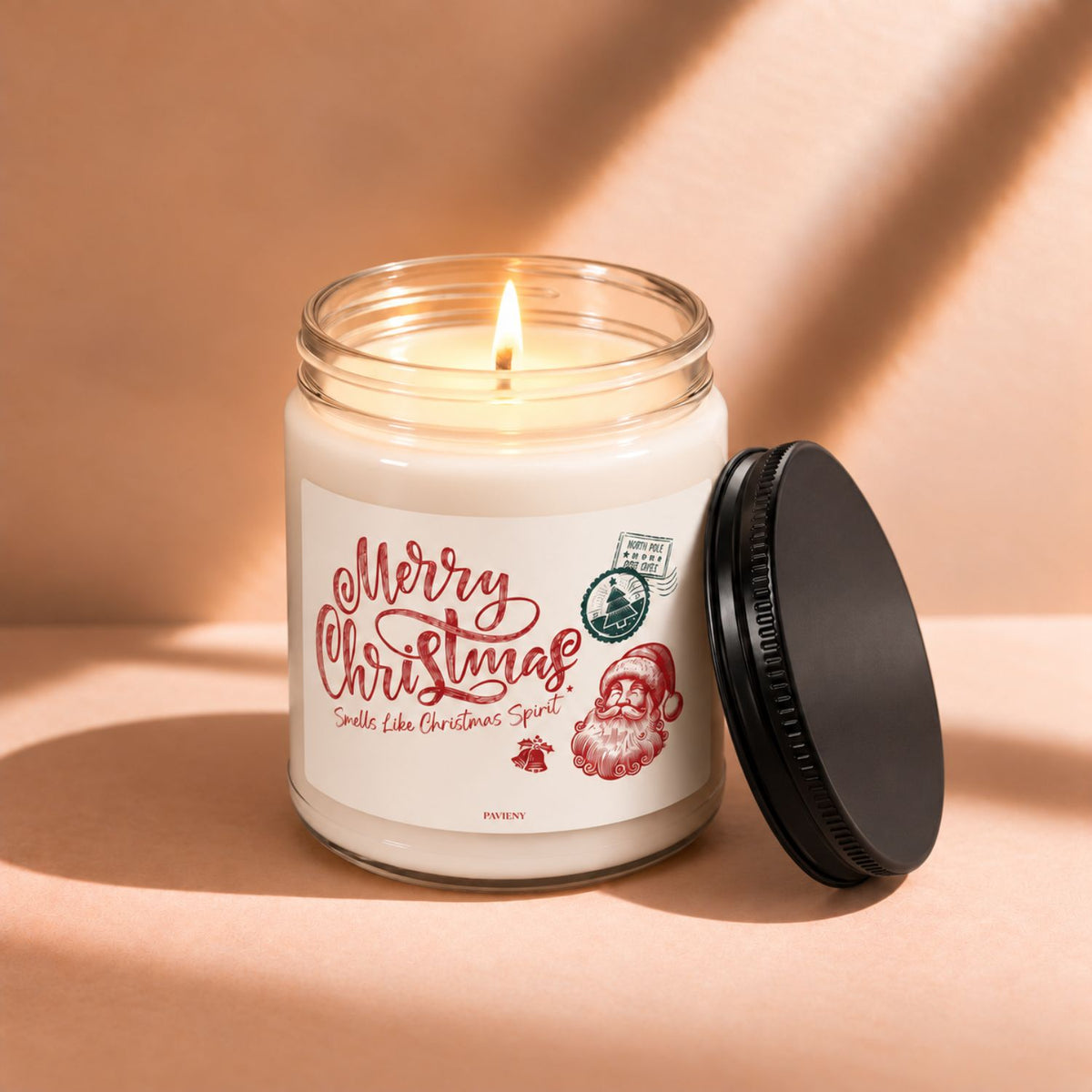 Lit 9oz Merry Christmas scented soy candle with a warm flame and festive holiday design.