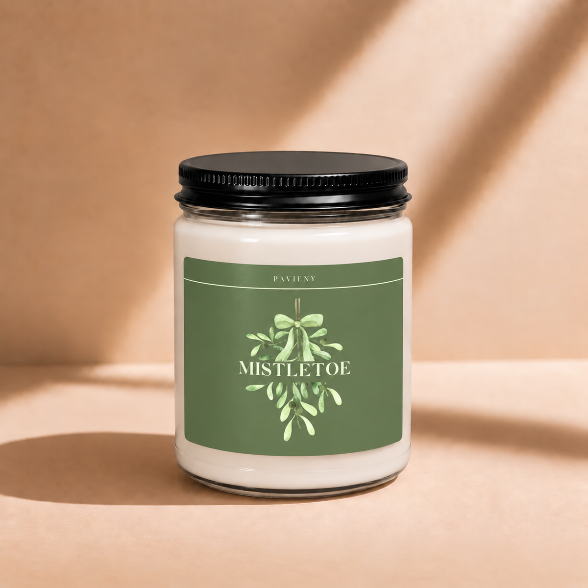 Closed 9oz Mistletoe scented soy candle with a black lid, a cozy Christmas gift for friends and loved ones.