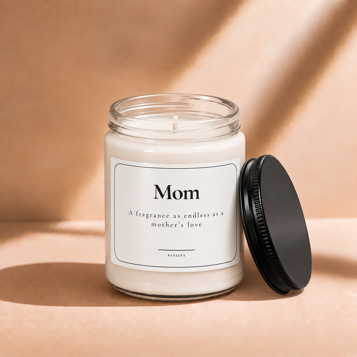 Open 9oz Mom scented soy candle with the black lid beside the clear glass jar.