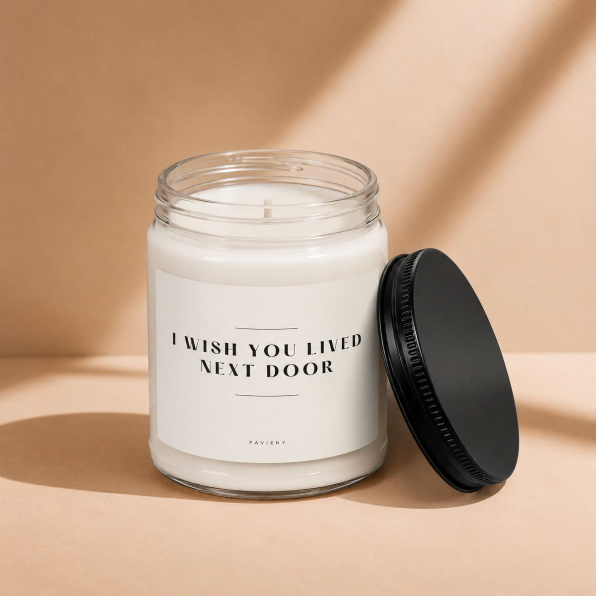 Next Door scented candle with the wax and wick visible, a charming gift for neighbors and housewarmings.