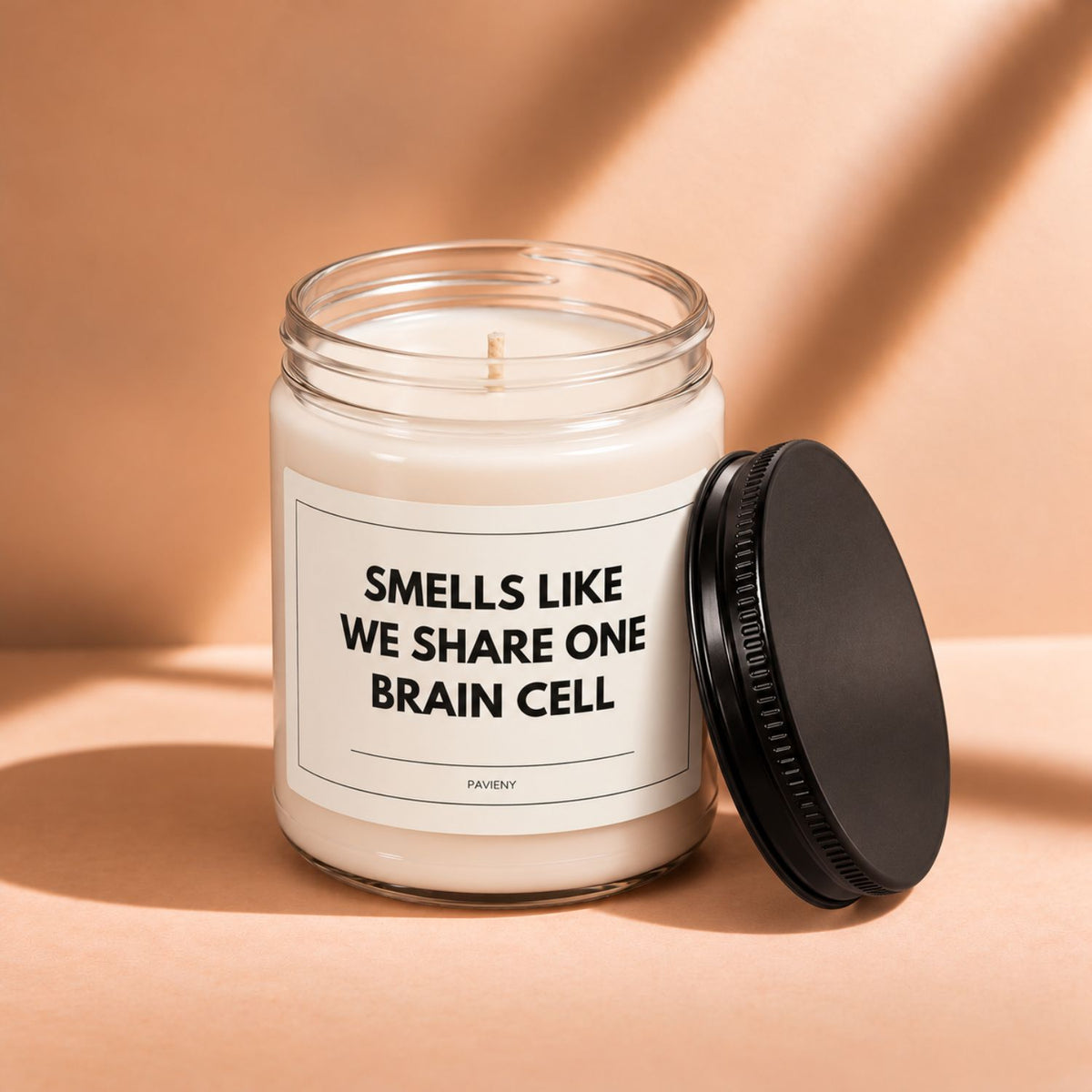 Open 9oz One Brain Cell scented soy candle with the black lid beside the clear glass jar.