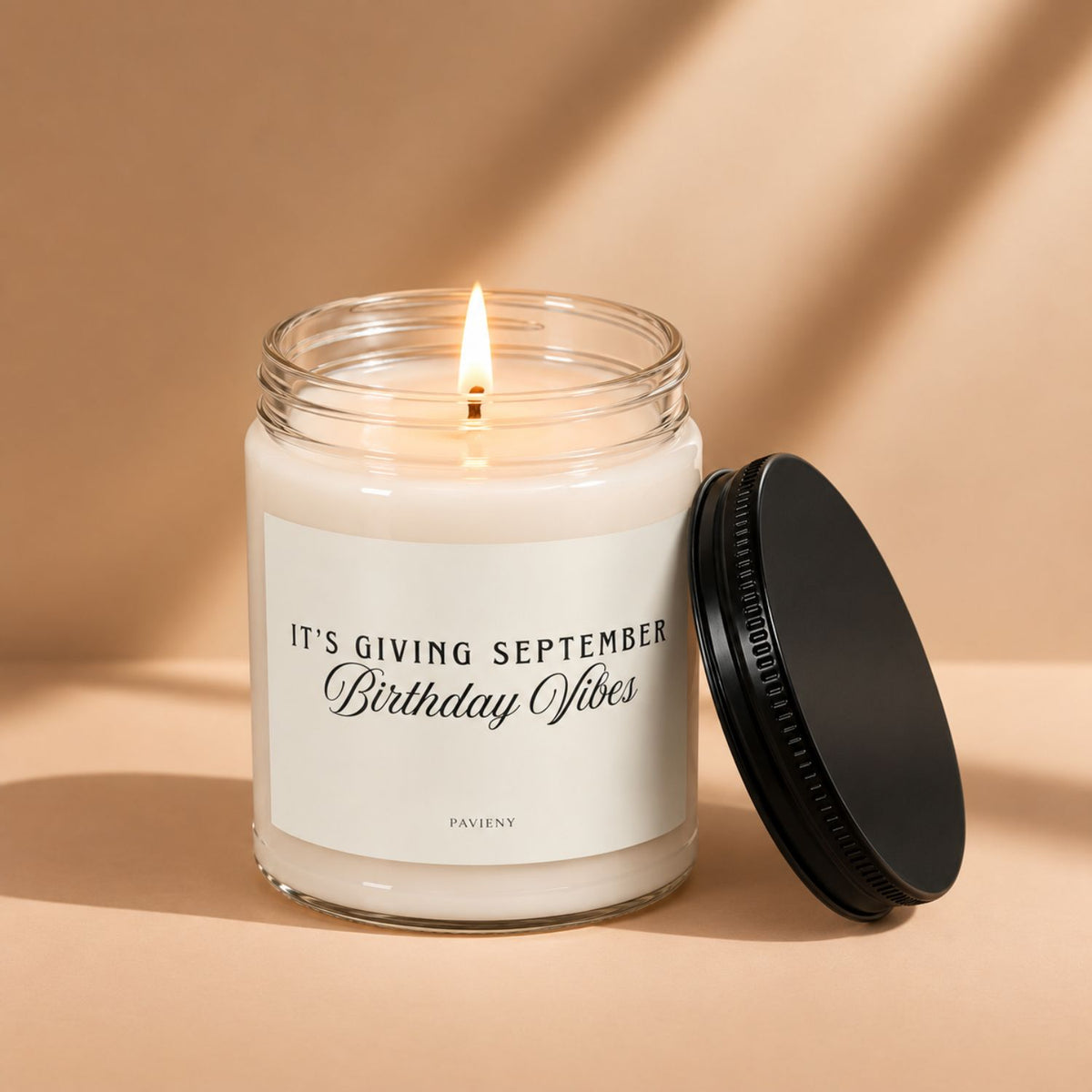 Lit September birthday scented candle in a glass jar, a thoughtful gift for someone celebrating a September birthday.