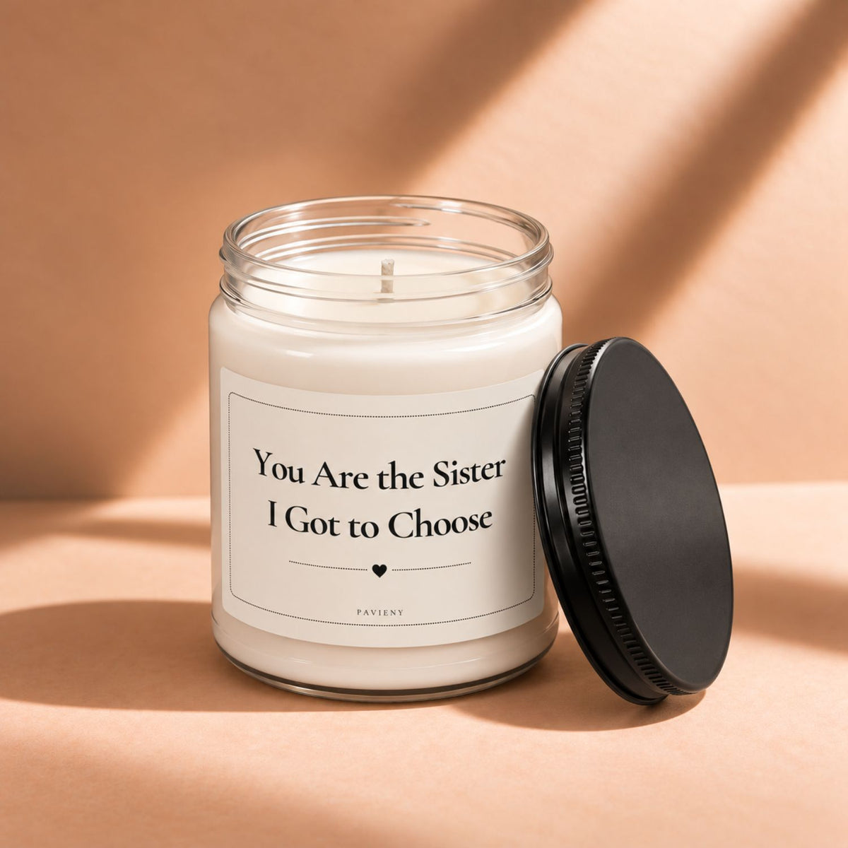 Open 9oz Sister I Got to Choose candle with the black lid beside the clear glass jar.