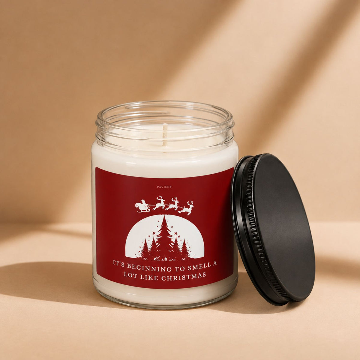Open Smells Like Christmas candle by Pavieny, version 2, showing the wax surface and cotton wick inside the glass jar.