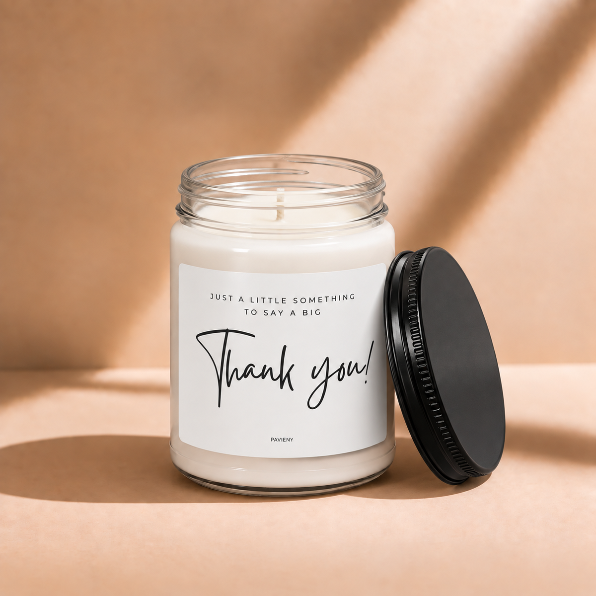 Open 9oz Thank You scented soy candle with the black lid beside the clear glass jar.
