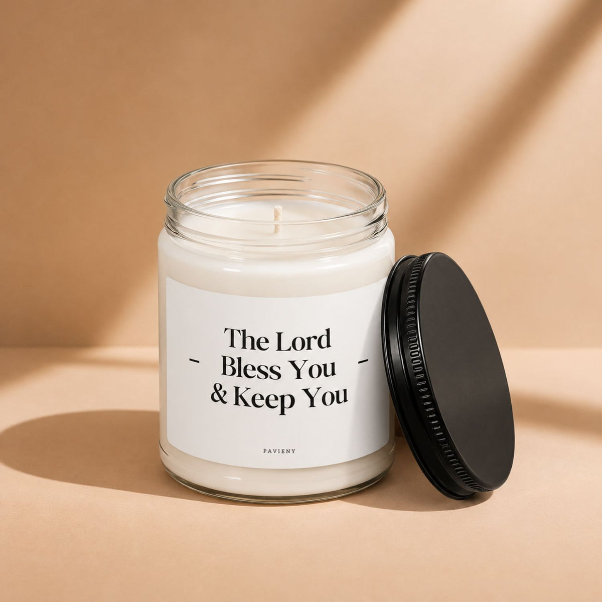 Open The Lord Bless You candle by Pavieny showing the soy wax surface and cotton wick inside the glass jar.