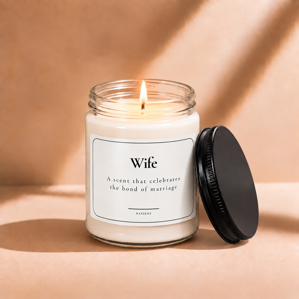 Lit 9oz Wife scented soy candle with a warm flame, a romantic gift for wives on anniversaries, birthdays, or special occasions.